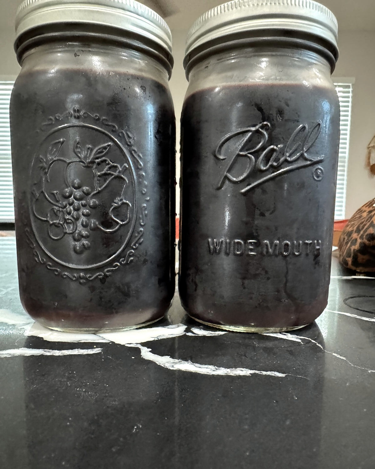 Two 32 oz mason jars of Essie’s Apothecary elderberry syrup