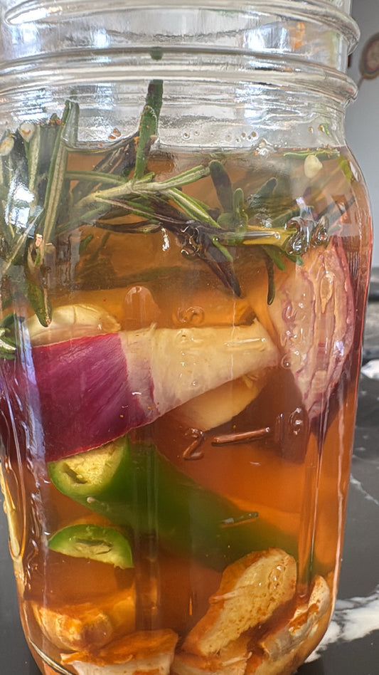 Fire Cider botanicals steeping in apple cider vinegar